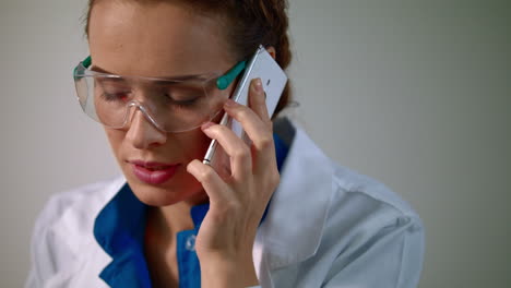 Researcher-woman-speaking-on-mobile-phone.-Female-researcher-in-lab-glasses